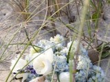 a wedding bouquet of white peonies, blue hydrangeas and seashells for a beach bride