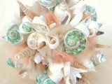 a unique beach wedding bouquet of neutral tulle, seashells of bright tones is a gorgeous option for a beach bride