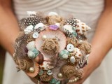 a bright and non-typical wedding bouquet composed of buttons, pearls, seashells and feathers