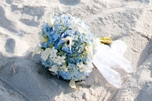 a beautiful white and blue wedding bouquet with a neutral and airy wrap for a beach bride