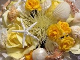 a bold beach wedding bouquet composed of white and yellow blooms, seashells and starfish