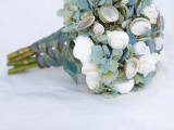a simple greenery wedding bouquet with white seashells and mussel shells is a chic idea for a beach bride