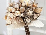 a beach wedding bouquet of dark and neutral seashells and a dark wrap is a pretty idea for a beach wedding