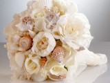 a neutral wedding bouquet of seashells and blooms plus some pearls looks very elegant