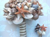 a non-traditional beach wedding bouquet of seashells, starfish and a simple ribbon wrap