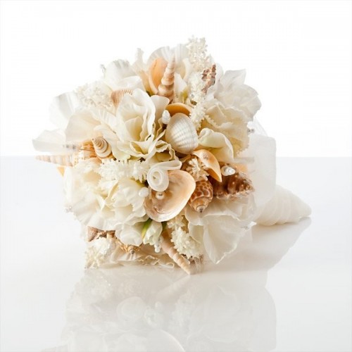 a chic neutral wedding bouquet of blooms, seashells and coral looks very cool and elegant