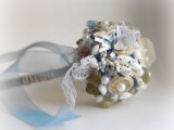 a quirky wedding bouquet with shells, pearls, neutral pebbles and ribbons for decor