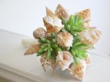 a unique beach wedding bouquet of neutral shells and succulents looks very unusual