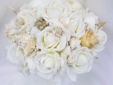 a neutral beach wedding bouquet of white blooms, shells and rhinestones will sparkle at the wedding