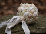 a blush and white ball wedding bouquet fully made of seashells