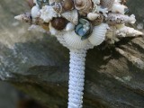 a chic beach wedding bouquet of neutral, green and brown seashells, pearls and rope wrap