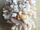 a neutral beach wedding bouquet of seashells, starfish and other sea-inspired stuff
