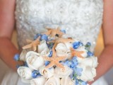 a blue and white wedding bouquet with starfish for a beach bride