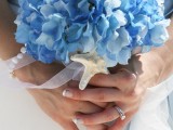 a beach wedding bouquet of blue hydrangeas and a single starfish as an accent