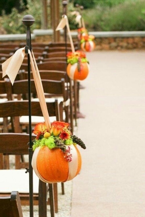 pumpkins works well to decorate a fall's wedding aisle