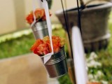 hanging buckets with bright orange roses are amazing to line up the aisle and make it bolder and cooler