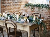 a textural greenery table runner and succulents on each place setting for a stylish look