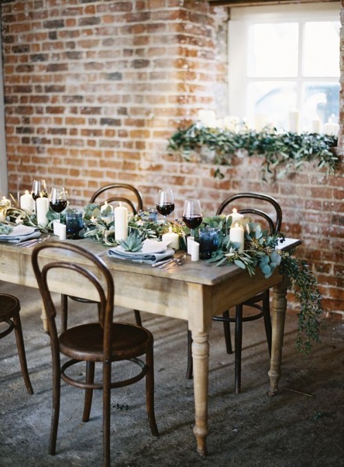 a textural greenery table runner and succulents on each place setting for a stylish look