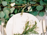 a silver penny eucalyptus and white bloom table runner is a gorgeous idea