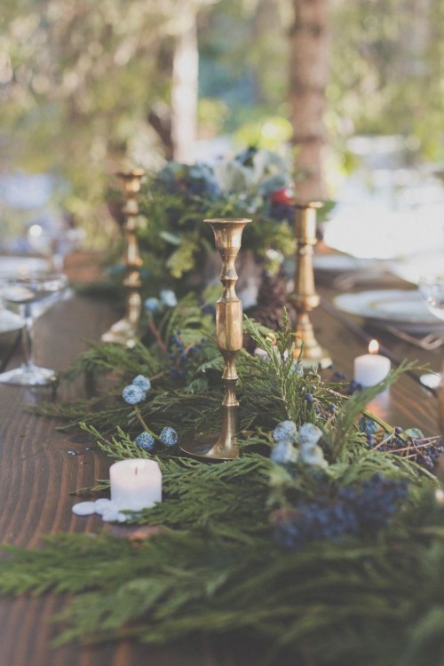 a fir and fern table runner with blueberries and gilded candle holders for a winter tablescape