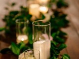 a foliage table runner, white roses, white candles to create an exquisite tablescape