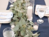 a eulcalyptus table runner combined with a navy one is a stylish idea for a modern wedding table setting