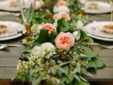 a chic greenery table runner spruced up with neutral and blush blooms on top