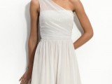 a neutral A-line short strapless dress with a sheer strap on one shoulder and a pleated skirt will match many styles