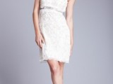 a white lace embellished over the knee dress on spaghetti straps and with an embellished sash for a glam bride
