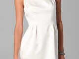 a modern plain mini dress with a high neckline, a wide collar and a pleated skirt is a chic idea