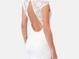 a fitting white lace knee dress with cap sleeves, a high neckline and a cutout back is a stylish and chic idea