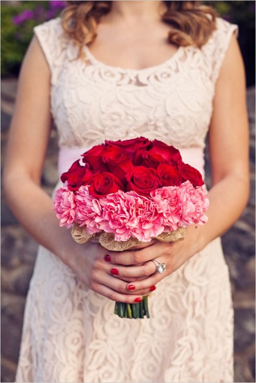 a bold red and pink wedding bouquet of roses and carnations is a statement idea for a Valentine's Day bride