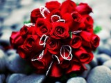 a refined red rose wedding bouquet with rhinestones is a bold glam idea for a Valentine’s Day bride