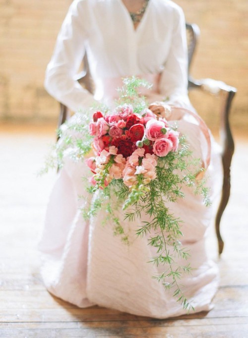 a refined red, pink and blush wedding bouquet with greenery and an ombre effect is a chic idea for a Valentine bride