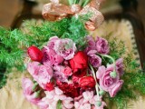 a bright Valentine wedding bouquet of pink, lavender and red blooms and greenery shows off all the traditional Valentine colors