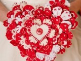 a bold red and white heart-shaped Valentine wedding bouquet with a button on one of hearts is a lovely and bold idea to rock