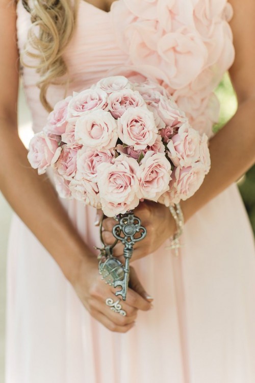 a lovely blush rose wedding bouquet with a wrap and vintage keys for detailing for a Valentine vintage bride