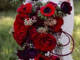 a refined red and deep purple wedding bouquet with greenery and pale greenery is a cool idea for a color-loving bride