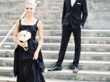 a black A-line wedding dress with thick straps and a square neckline plus a pleated skirt and a white wedding bouquet for a chic modern wedding