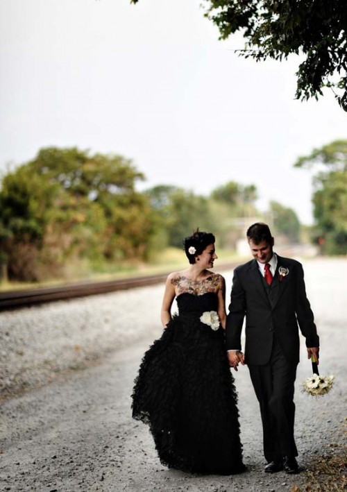 a strapless black wedding dress with a draped bodice and a ruffle skirt is a stylish idea for a modern black wedding