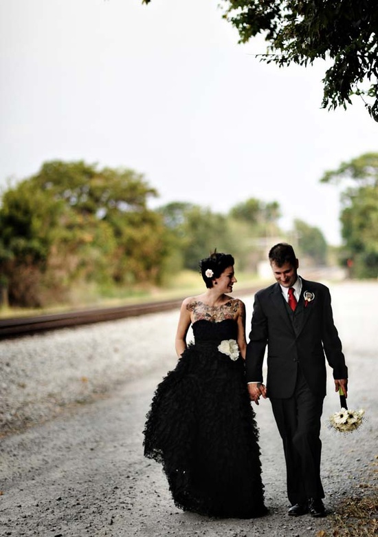 A strapless black wedding dress with a draped bodice and a ruffle skirt is a stylish idea for a modern black wedding