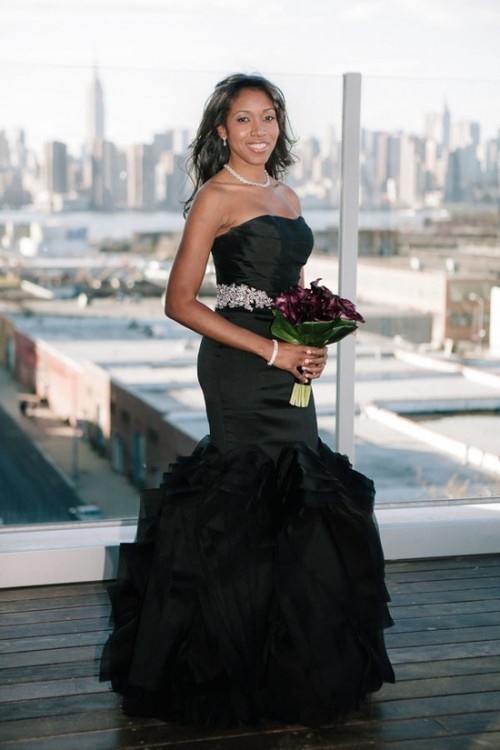 a strapless black mermaid wedding dress with a ruffle skirt and an embellished sash is an amazing idea