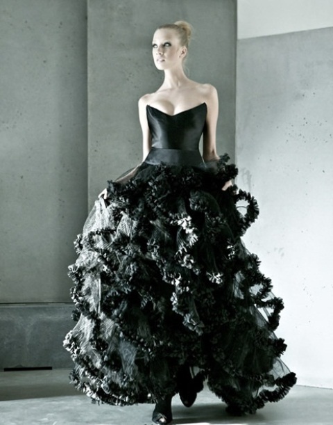 a jaw-dropping strapless black wedding ballgown with a shiny bodice with sharp corners and a ruffle multi-tier skirt for a bold statement