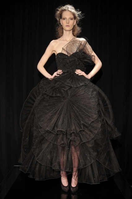 a unique black embellished strapless wedding dress with black sheer petals all over the dress is a very unusual solution