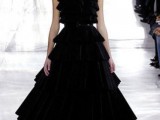 a black wedding ballgown with a tiered full skirt and a ruffle bodice with cap sleeves and a high neckline is amazing