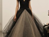 a dramatic black and tan wedding ballgown with a plunging neckline, no sleeves and a layered skirt with a train is amazing
