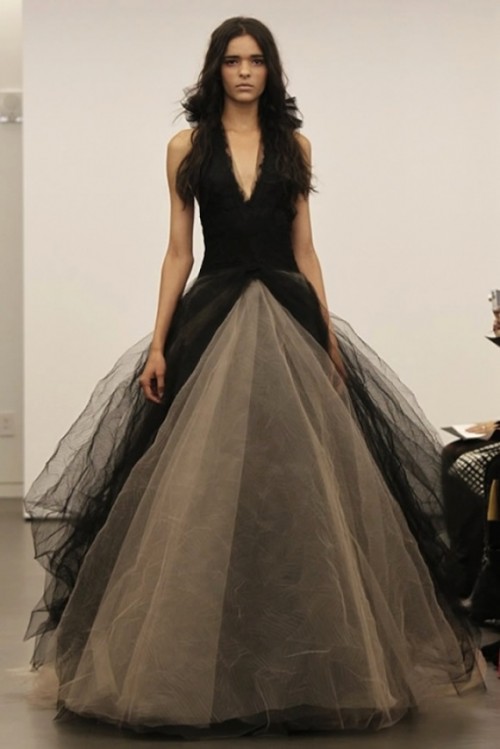 a dramatic black and tan wedding ballgown with a plunging neckline, no sleeves and a layered skirt with a train is amazing