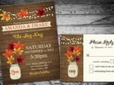 a rustic-inspired wedding invitation suite styled as a wooden plank invite, bright fall leaves and blooms printed on it