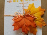 a fall wedding invitation suite with twine, colorful letters and bold fall leaves