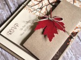 neutral fall wedding invitations with tress and colorful fall leaves attached with twine